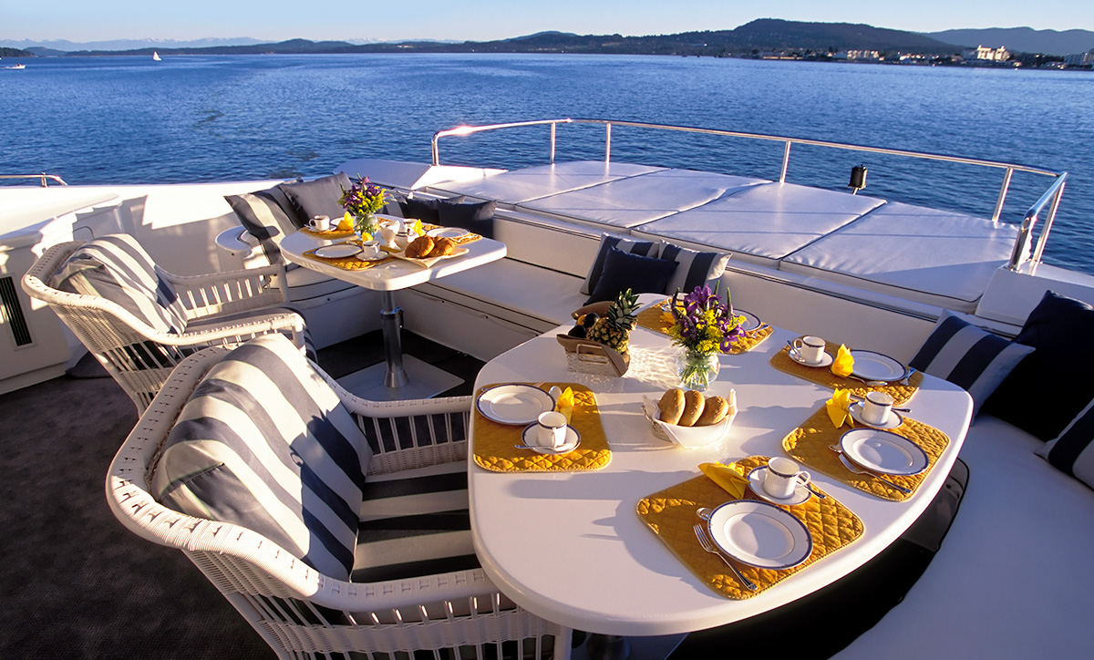 Breakfast setting on the deck of a private yacht.