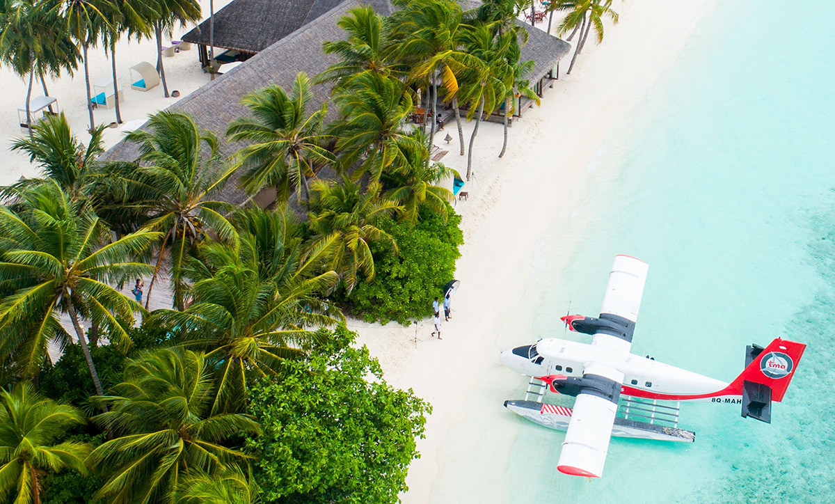 Seaplane on the beach of an exclusive private luxury travel resort.